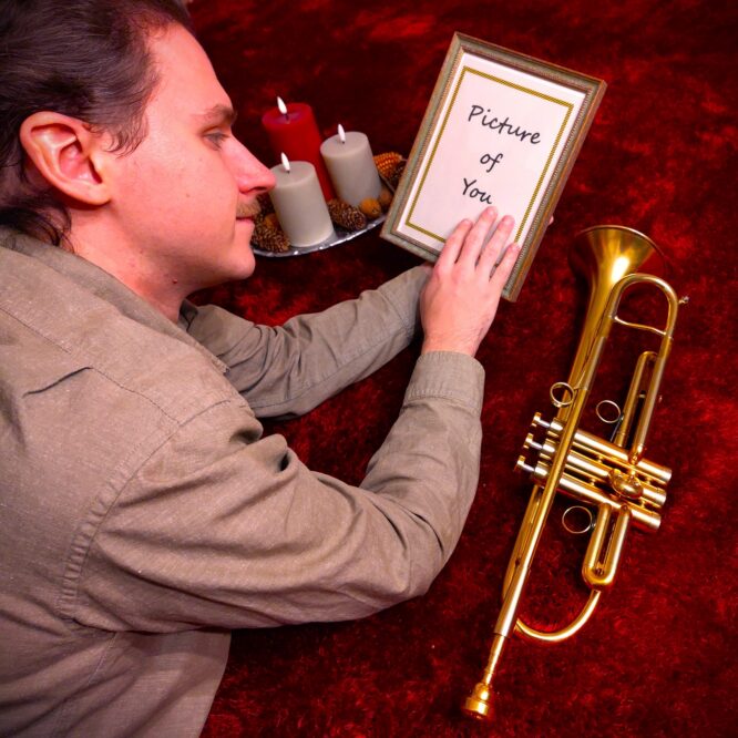 Mitgenosse on a red carpet, holding a picture of you.